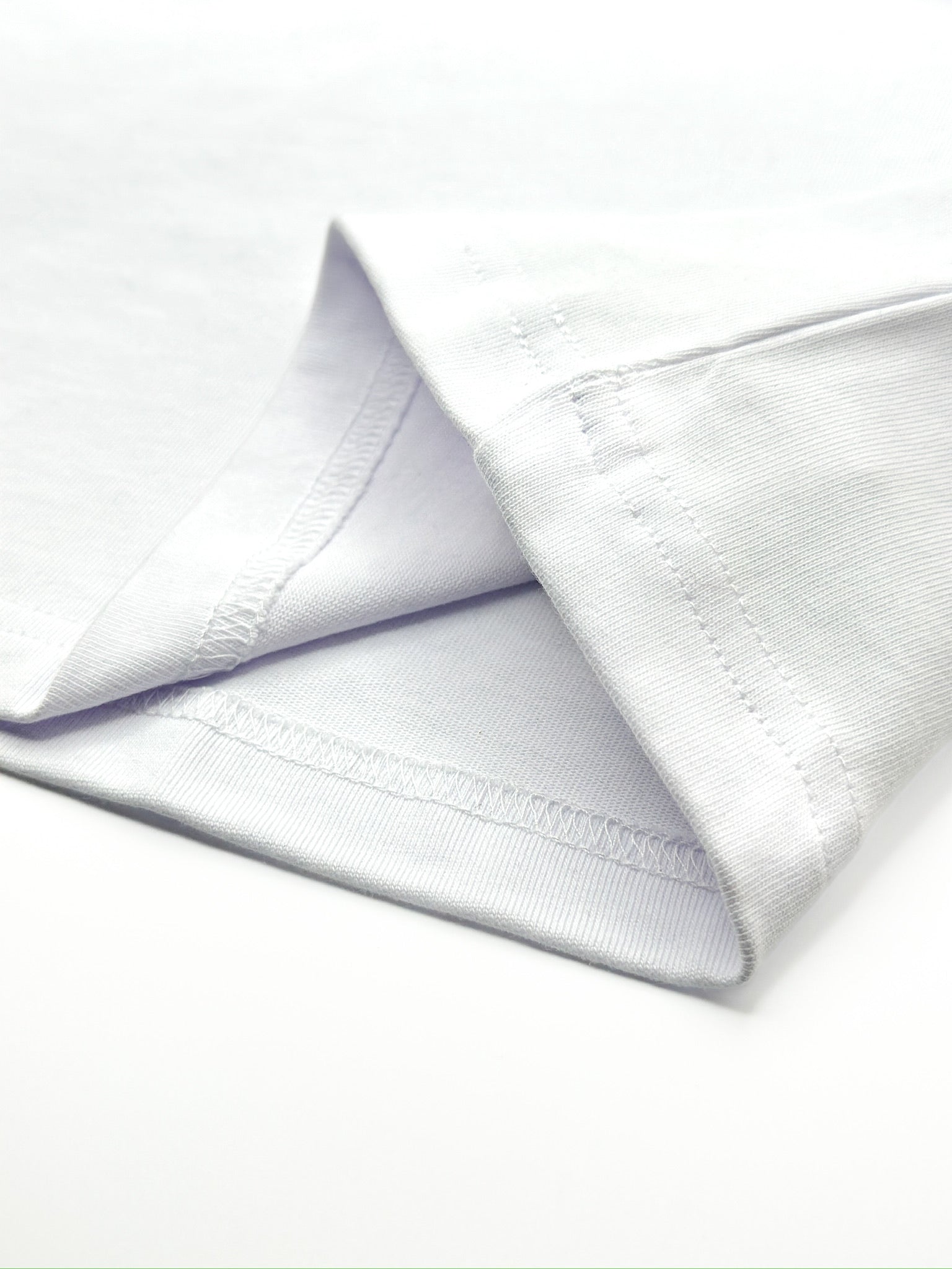 Close-up of a white shirt with folded collar on a white background