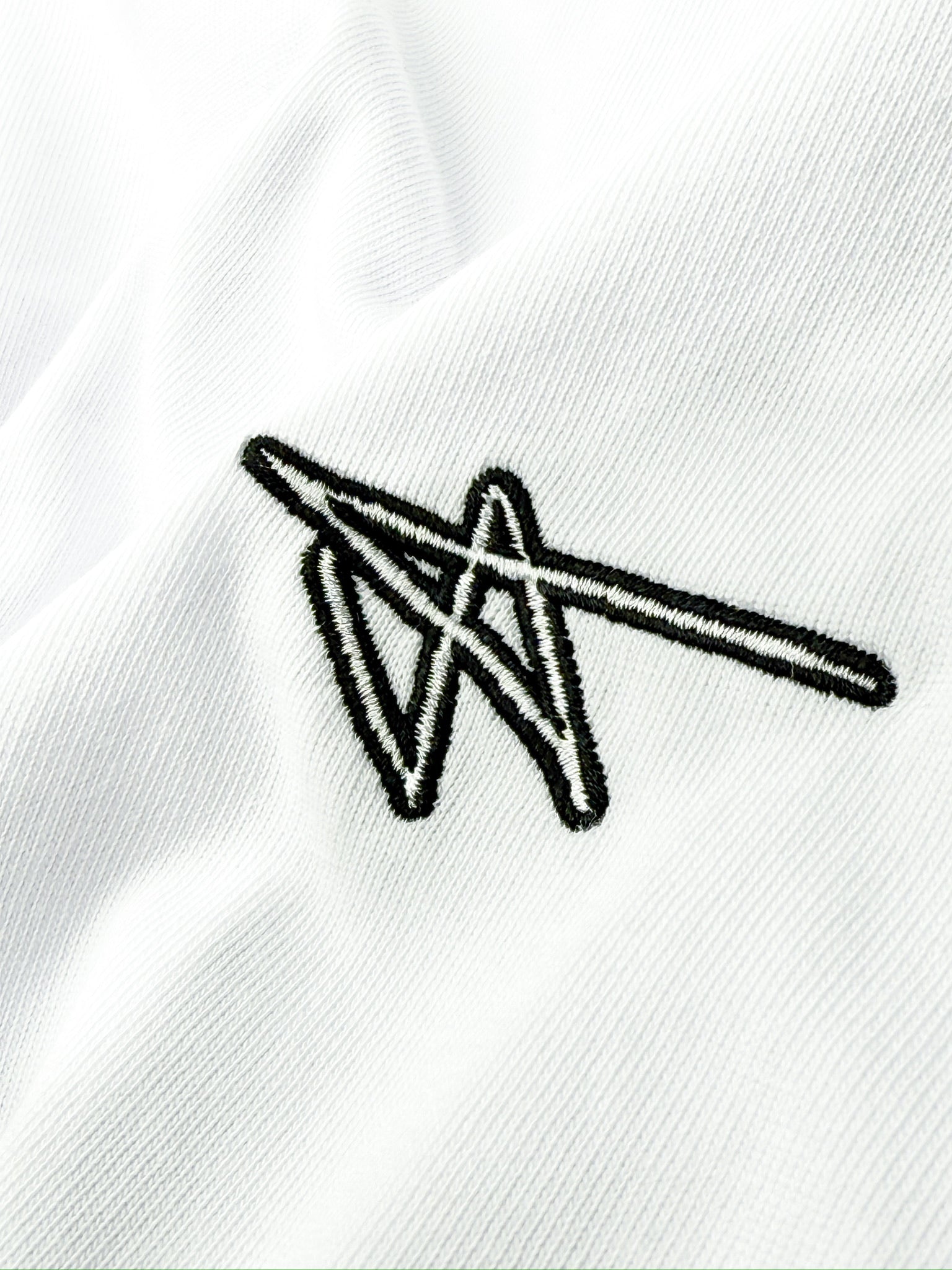 Black geometric logo on a white fabric background